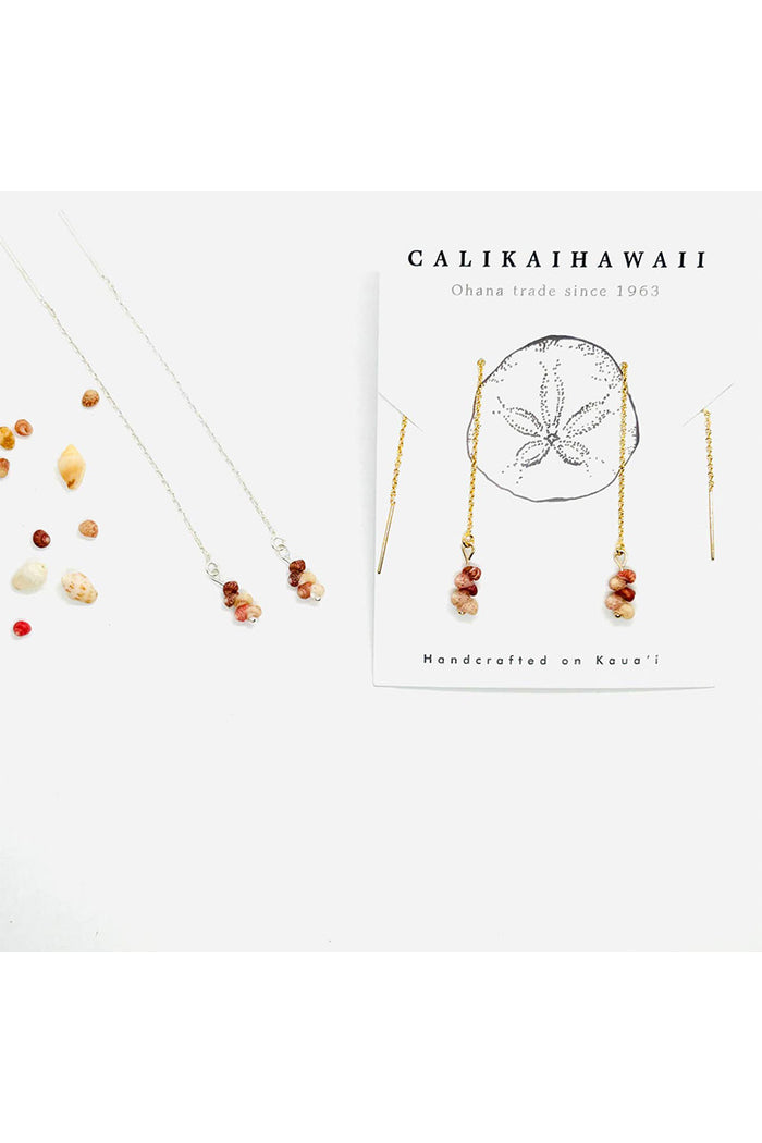 Jewelry set with necklaces and earrings on a white background, featuring the brand 'Calikai Hawaii'.