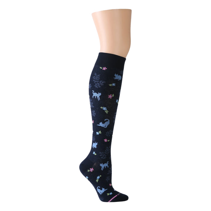 Knee-high compression socks featuring a navy background with cat and floral patterns in various colors.