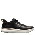 Green sneaker with a beige sole on a light gray background